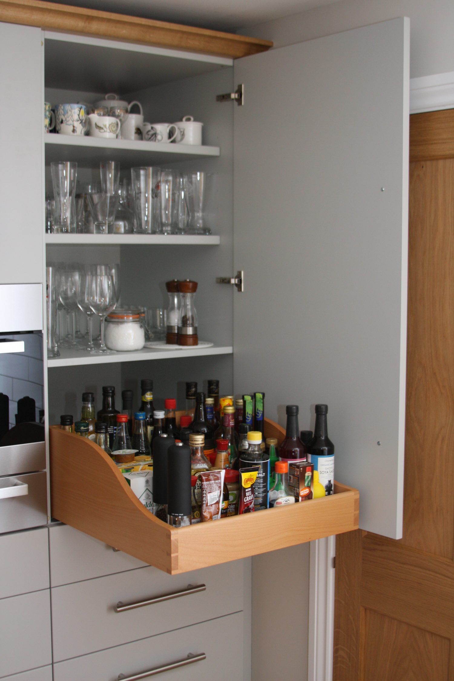 Larder cupboard with pull out tray